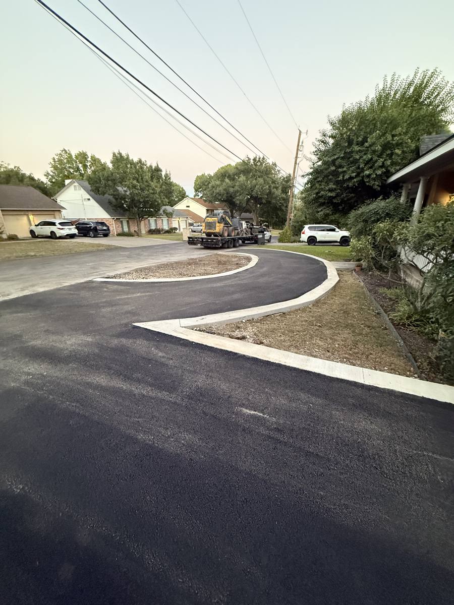 Asphalt road with new concrete curb