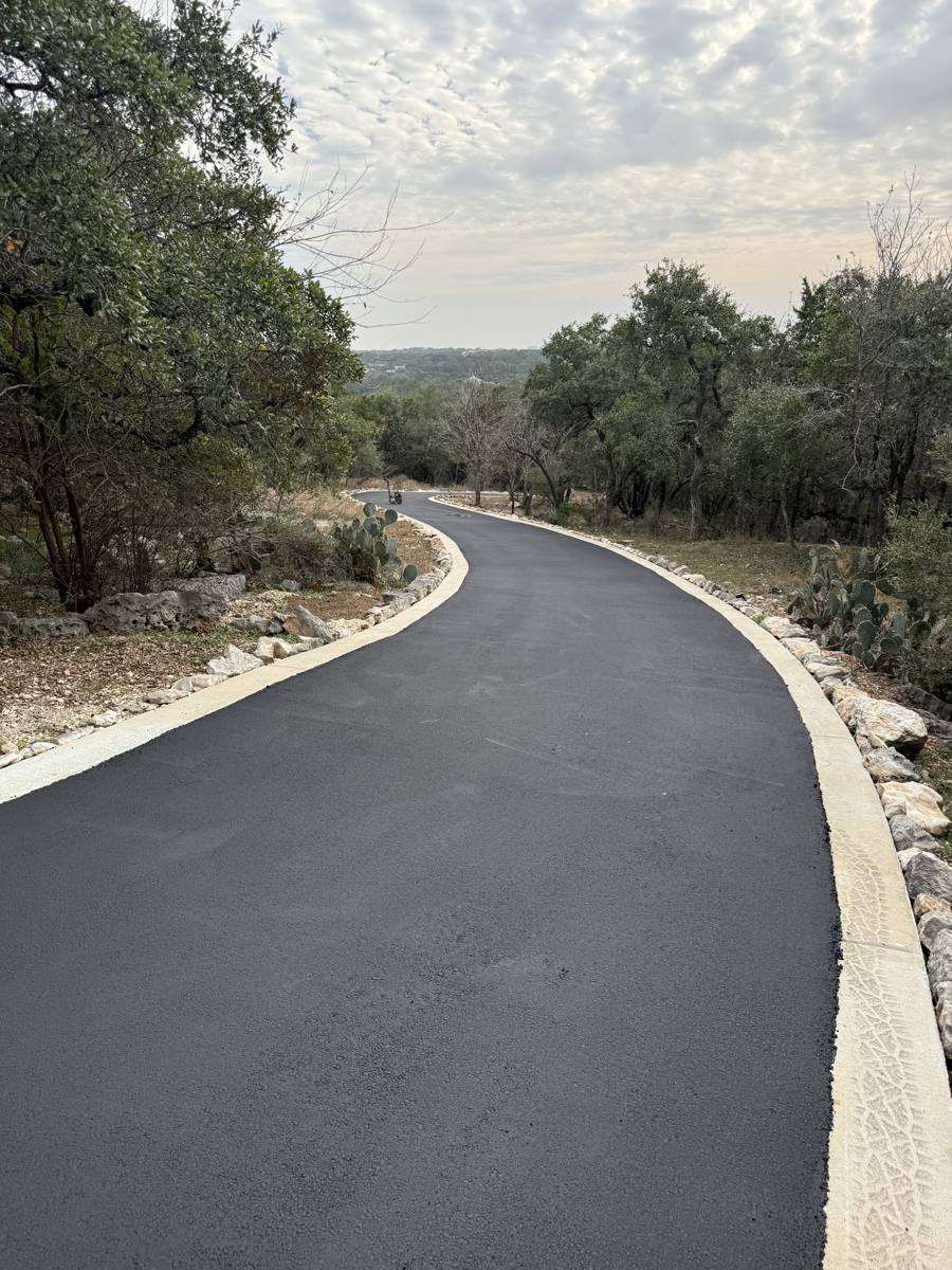 Curved asphalt driveway with edge curbing
