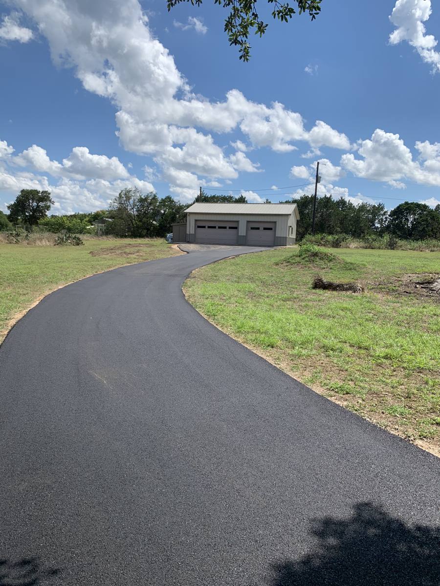 Long rural asphalt driveway